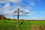 Thumbnail large metal cross which guards an oilseed rape field